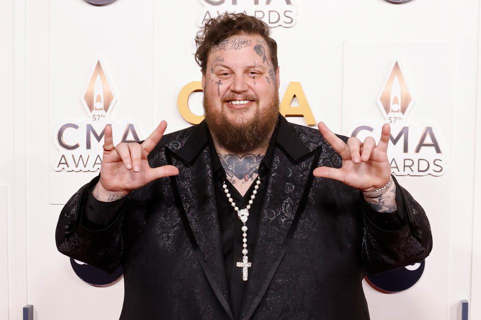 Jelly Roll puts up 'I love you' in sign language on the CMA Awards carpet