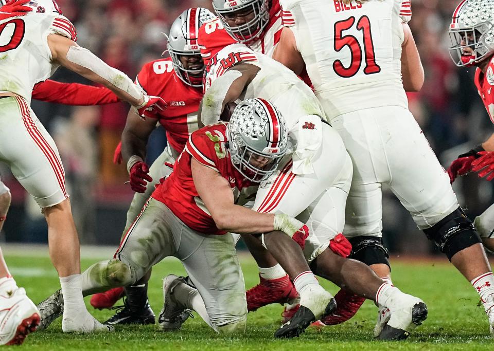 Ohio State linebacker Tommy Eichenberg tackles Utah's Tavion Thomas during the Rose Bowl. The Buckeyes ranked No. 59 in total defense last year.