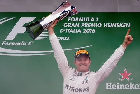 Formula One - F1 - Italian Grand Prix 2016 - Autodromo Nazionale Monza, Monza, Italy - 4/9/16 Mercedes' Nico Rosberg celebrates his win on the podium with the trophy Reuters / Max Rossi Livepic