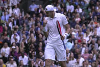 John Isner of the US celebrates winning a point against Britain's Andy Murray during their singles tennis match on day three of the Wimbledon tennis championships in London, Wednesday, June 29, 2022. (AP Photo/Alastair Grant)