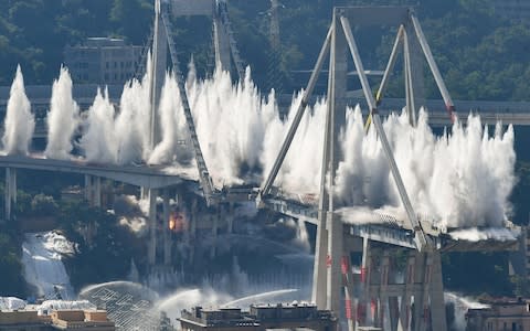 Explosive charges blow up the eastern pylons of Genoa's Morandi motorway bridge that killed 43 people - Credit: &nbsp;VINCENZO PINTO/AFP