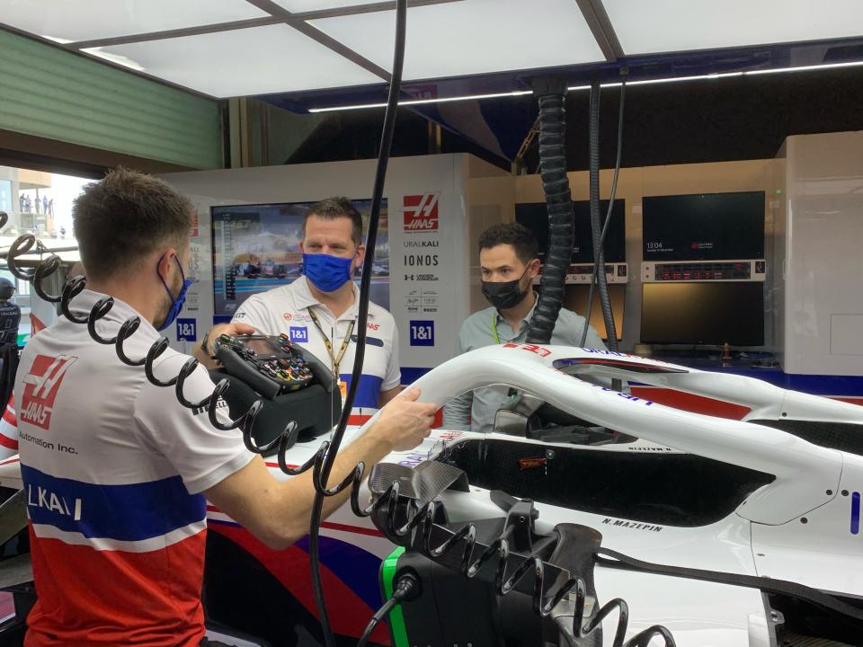 NASCAR champion Kyle Larson gets a close look of a Formula One car and a tour of the Haas garage on Sunday, Dec. 12, 2021 at Yas Marina Circuit before the Formula One season-ending Abu Dhabi Grand Prix. Larson attended his first ever F1 race as part of his weeklong visit to Dubai and Abu Dhabi during a vacation following his Cup championship win. (AP Photo/Jenna Fryer)