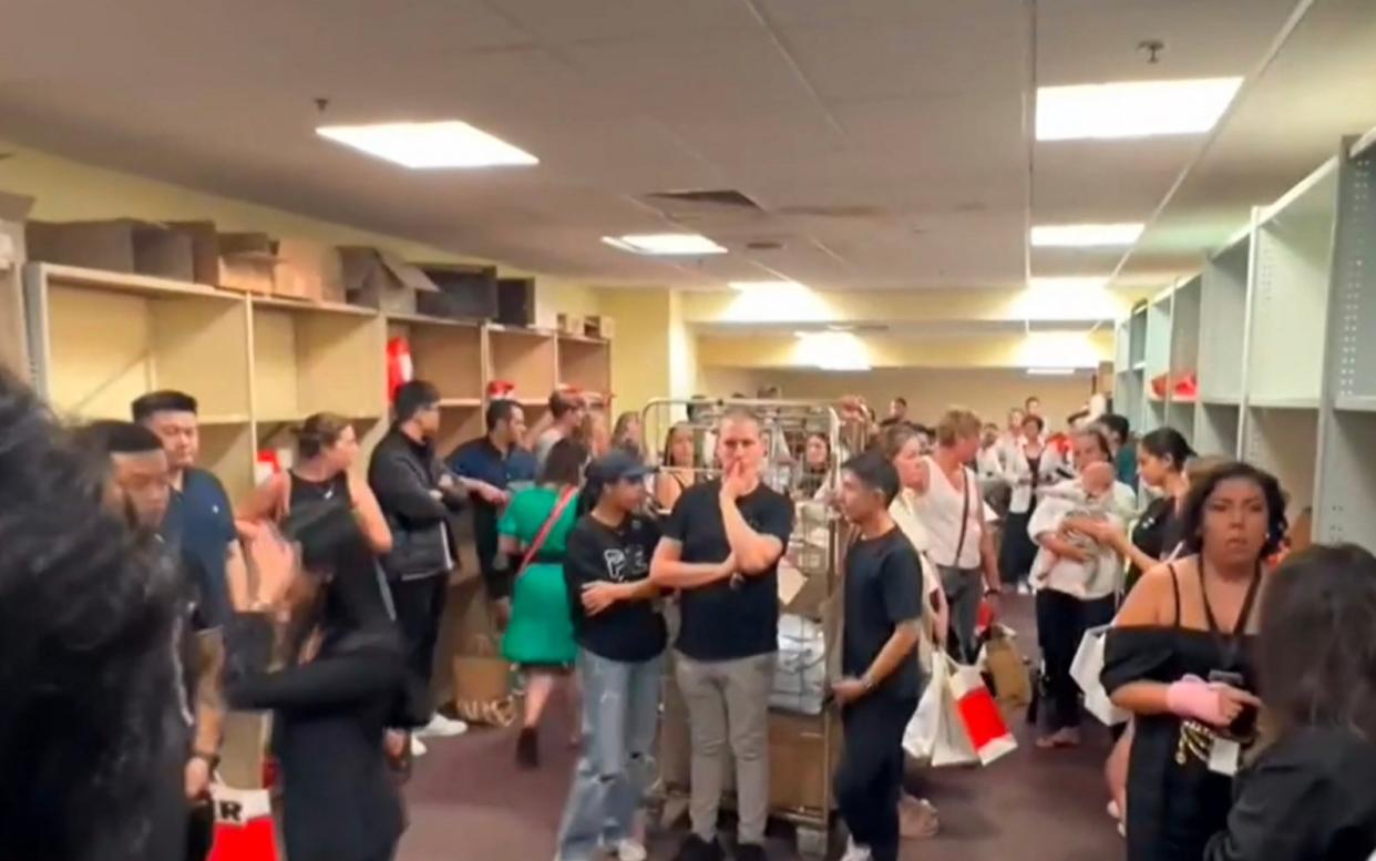 People take refuge in a room inside the shopping centre