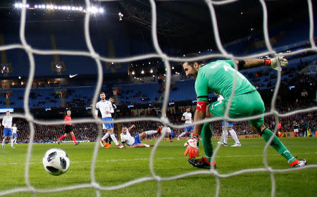 Soccer Football - International Friendly - Italy vs Argentina - Etihad Stadium, Manchester, Britain - March 23, 2018 Argentina’s Ever Banega scores their first goal as Italy’s Gianluigi Buffon reacts REUTERS/Phil Noble