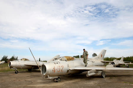 An Albanian Air Force crew member walks on a wing of the MiG-19 jet fighter in Kucova Air Base in Kucova, Albania, October 3, 2018. REUTERS/Florion Goga