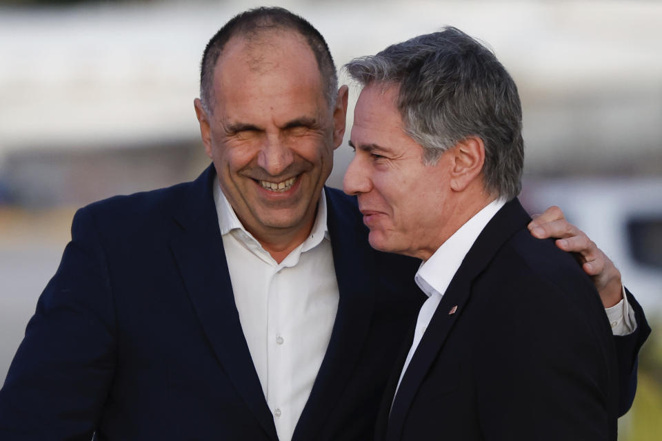 Greek Foreign Minister George Gerapetritis, left, greets U.S. Secretary of State Antony Blinken, right as he arrives on the island of Crete, Greece, Saturday, Jan. 6, 2024 during his week-long trip aimed at calming tensions across the Middle East. (Evelyn Hockstein/Pool Photo via AP)