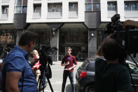 Reporters work outside the Anti-Corruption Office of the Judicial Police headquarters in Nanterre, outside Paris,Tuesday, June 18, 2019. Former UEFA president Michel Platini has been arrested in relation to a corruption probe into the awarding of the 2022 World Cup to Qatar, a judicial official said Tuesday. (AP Photo/Christophe Ena)