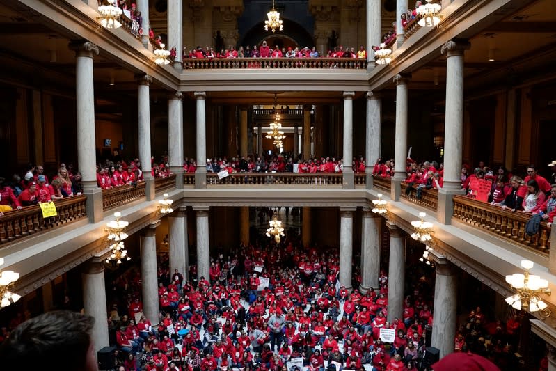 Educators and their supporters gather in the Capitol Building as teachers hold a one day walkout at the statehouse in Indianapolis
