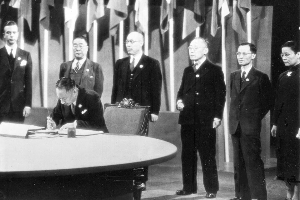 China's Ambassador to Britain Vi Kyuin Wellington Koo, signs the United Nations Security Charter, in San Francisco, on June 26, 1945. Behind standing are Parker Hart of the American State Department, left, and members of the Chinese delegation. The annual Asia-Pacific Economic Cooperation leaders' summit will be San Francisco's largest international gathering since 1945 when dignitaries gathered to sign the charter creating the United Nations. (AP Photo/File)