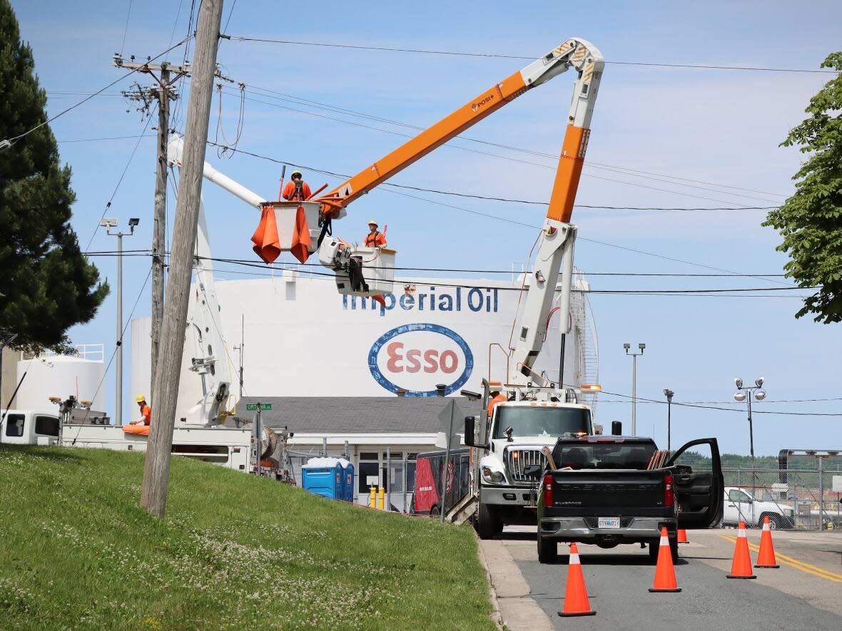Nova Scotia Power crews fully restored electricity to the north end of Sydney, N.S., on Monday at noon after a gas spill at the Imperial Oil facility on Friday. (Tom Ayers/CBC - image credit)