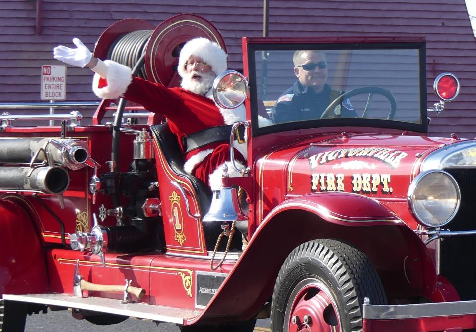The 75th Annual Victorville Christmas Parade on Saturday included a visit from Santa Claus, who rode a vintage fire truck along the parade route down Seventh Street.