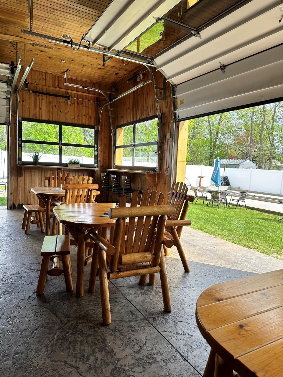Walthers Twin Tavern's patio area consists of the Lodge Room that opens to the outdoors for seating, cornhole and bocce.