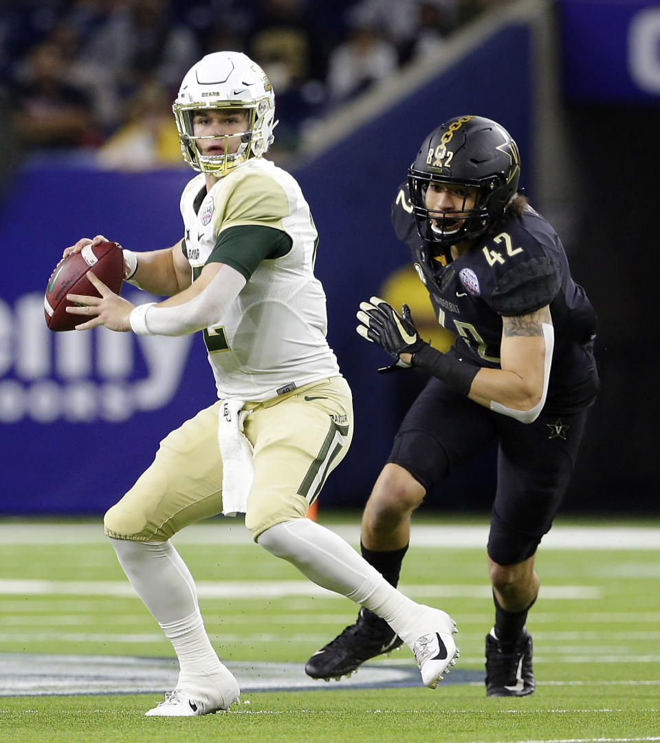 Baylor quarterback Charlie Brewer (12) looks to pass the ball as Vanderbilt linebacker Kenny Hebert (42) closes in during the first half of the Texas Bowl NCAA college football game Thursday, Dec. 27, 2018, in Houston. (AP Photo/Michael Wyke)