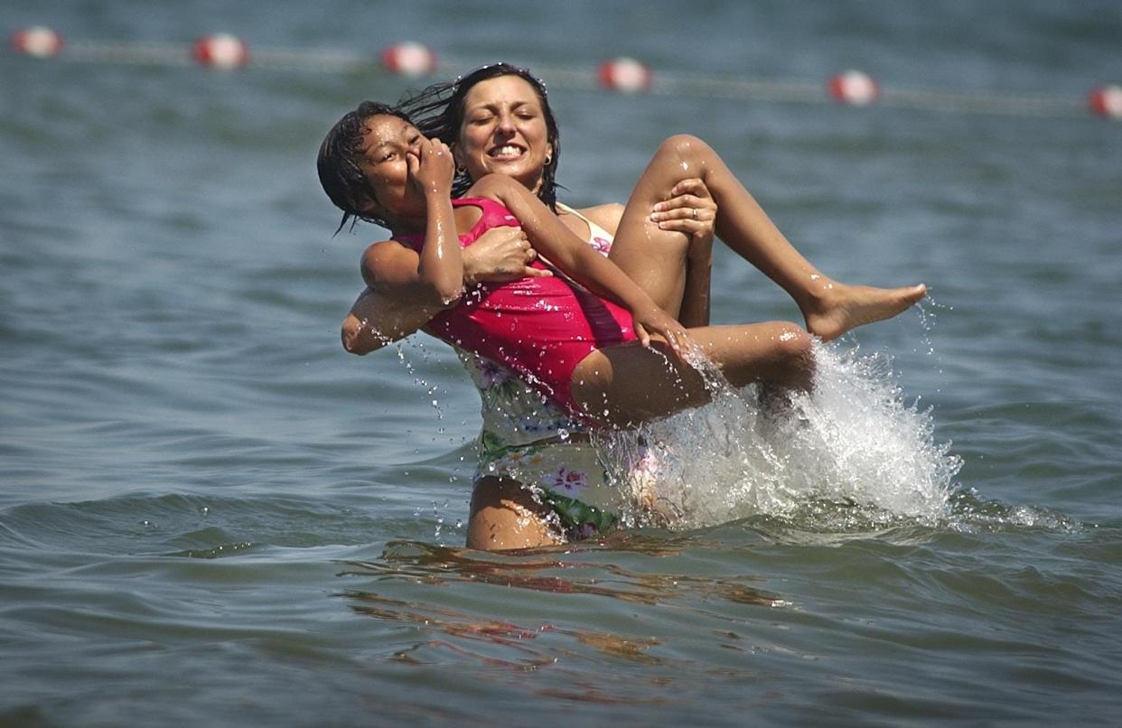 Mary Anne Antos of Irondequoit, played with her niece, Brittney Love, then 10, of Rochester, as they beat the heat at the public swimming beach at Durand Eastman Park in 2007.