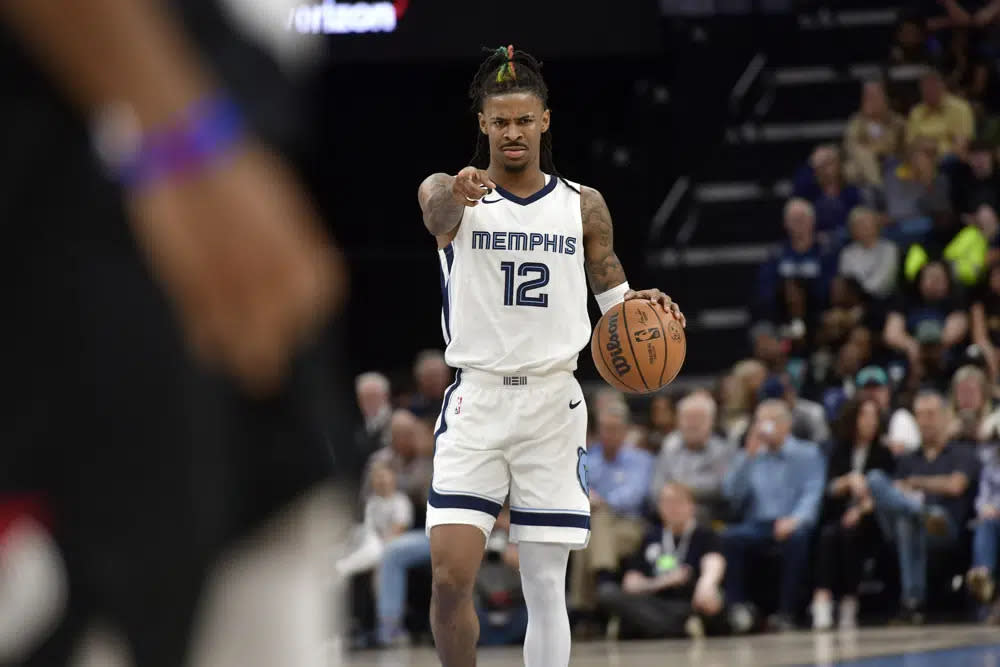 Memphis Grizzlies guard Ja Morant (12) handles the ball in the second half of an NBA basketball game against the Portland Trail Blazers Tuesday, April 4, 2023, in Memphis, Tenn. (AP Photo/Brandon Dill)