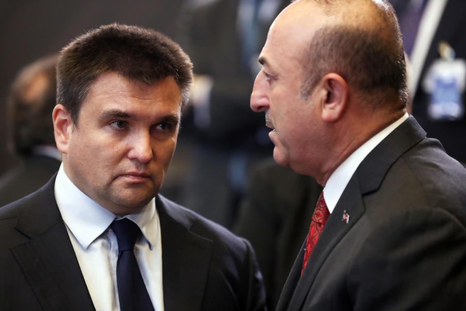 Turkish Foreign Minister Mevlut Cavusoglu, right, speaks with Ukraine's Foreign Minister Pavlo Klimkin during a round table meeting of the North Atlantic Council with Georgia and Ukraine at NATO headquarters in Brussels, Tuesday, Dec. 4, 2018. (AP Photo/Francisco Seco)