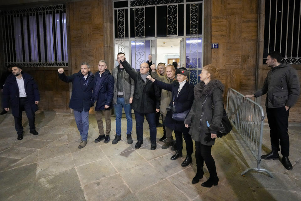 Serbian opposition leaders gesture during a protest joined by several thousand people, outside the country's electoral commission in Belgrade, Serbia, Monday, Dec. 18, 2023. An early official vote count of Serbia's weekend election on Monday confirmed victory for the ruling populist party in a parliamentary vote in the Balkan country, but political tensions rose over reported irregularities in the capital, Belgrade. (AP Photo/Darko Vojinovic)