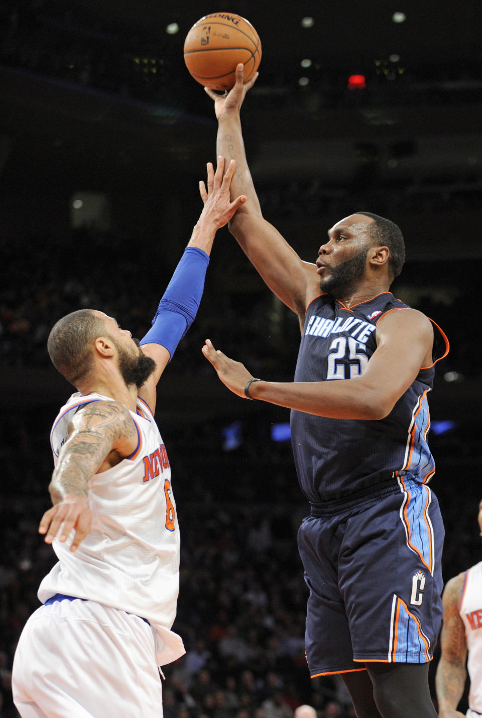 Charlotte Bobcats' Al Jefferson, right, attempts to shoot over New York Knicks' Tyson Chandler during the third quarter of an NBA basketball game, Friday, Jan. 24, 2014, at Madison Square Garden in New York. Jefferon led the Bobcats with 25 points but the Knicks won 125-96. (AP Photo/Bill Kostroun)