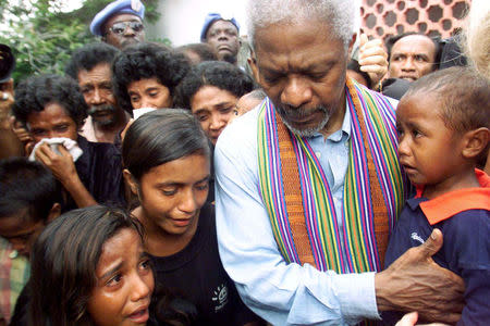 FILE PHOTO - United Nations Secretary-General Kofi Annan consoles family members of victims of last April's massacre by pro-Indonesia militia in Liquisa, 30 km west of DIli February 17, 2000. REUTERS/Darren Whiteside/File Photo