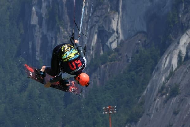 A kiteboarder soars through the air at the Squamish Spit during the annual Kite Clash tournament. (Jon Hernandez/CBC - image credit)