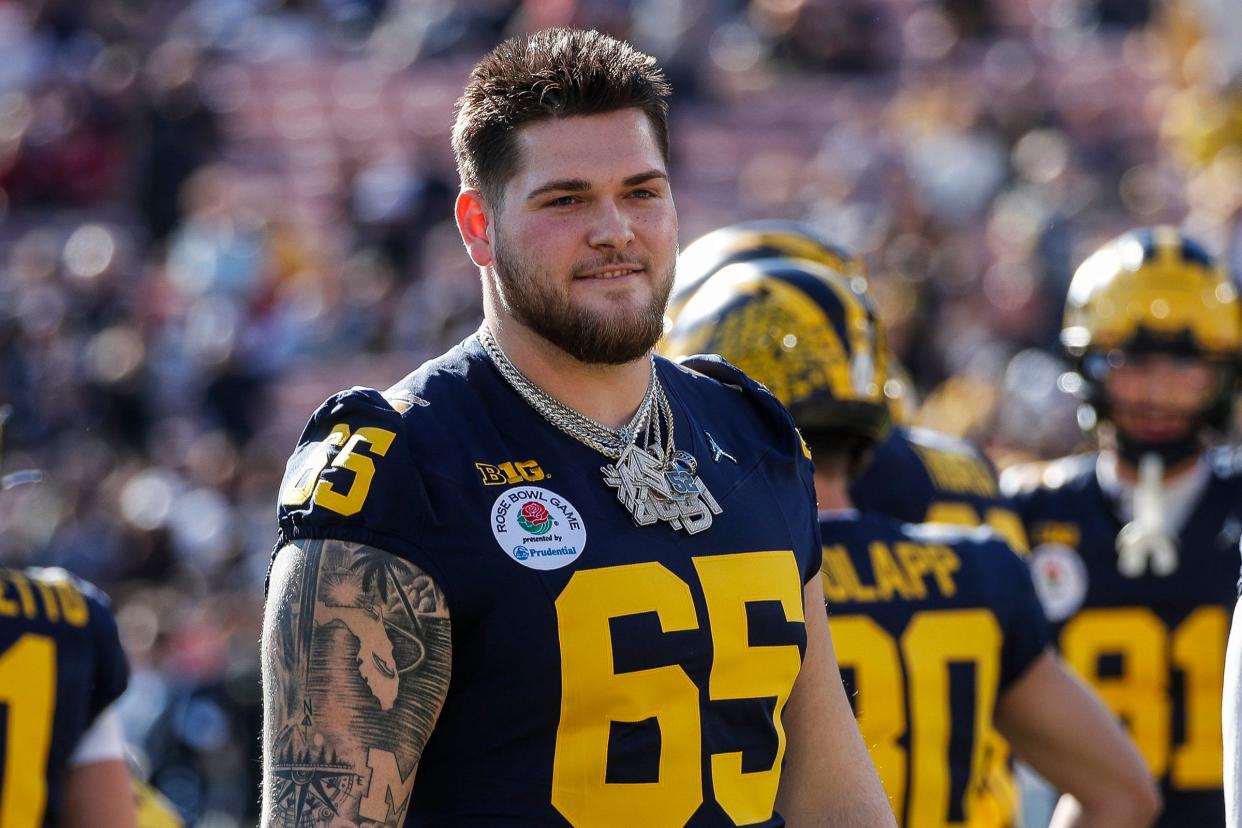 Michigan offensive lineman Zak Zinter (65) watches warm up ahead of the Rose Bowl game against Alabama at Rose Bowl Stadium in Pasadena, Calif., on Monday, Jan. 1, 2024.