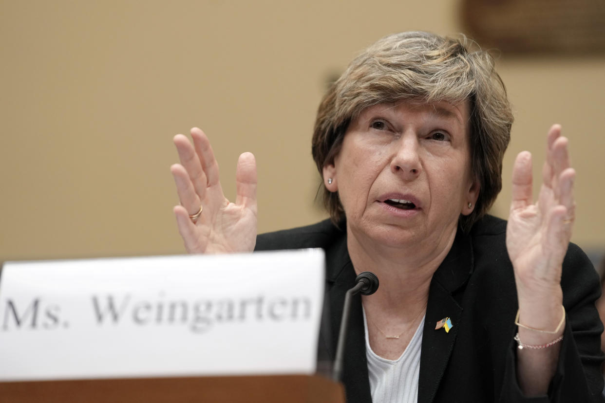 Randi Weingarten makes a point at the microphone.