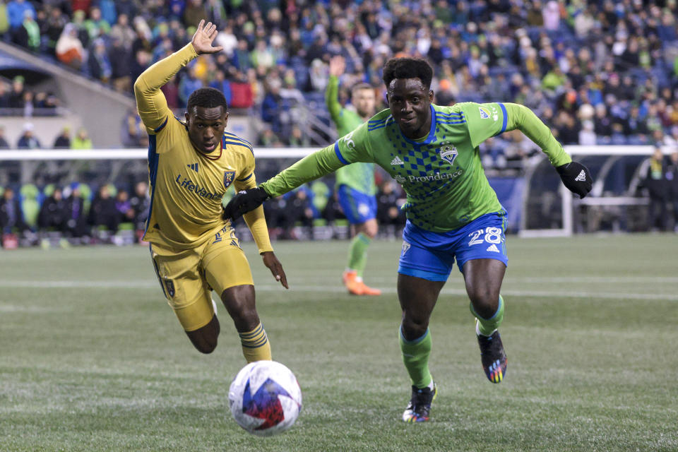 Real Salt Lake midfielder Anderson Julio, left, and Seattle Sounders defender Yeimar Gomez compete for the ball during the first half of an MLS soccer match Saturday, March 4, 2023, in Seattle. (AP Photo/Jason Redmond)