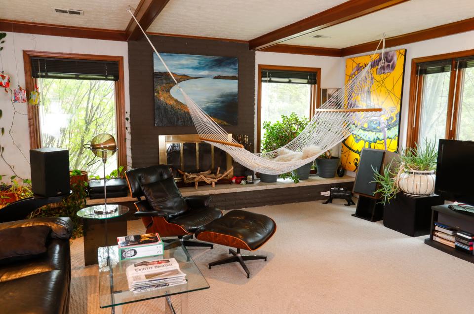The den of Larry Shapin and Ladonna Nicolas' home features a hammock, vintage furniture and artwork.