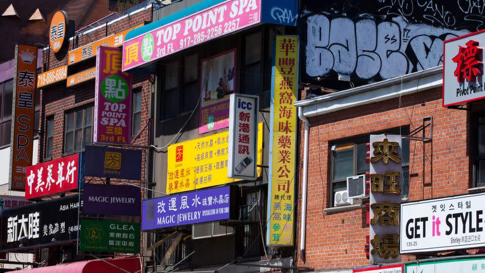 Signs in Mandarin cover buildings on Main Street in Flushing, in the borough of Queens. - Melanie Stetson Freeman/The Christian Science Monitor/AP