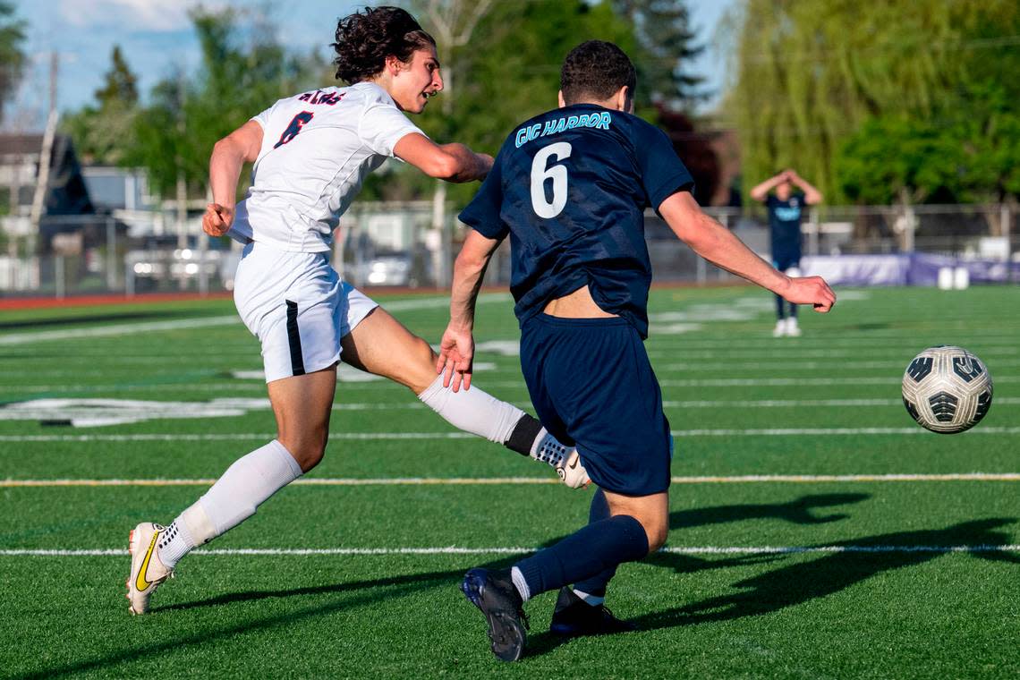 Silas’ Yusuf Mousa takes a shot on goal as Gig Harbor’s Caleb Gilbert defends during the second half of the 3A West Central/Southwest district soccer championship game on Thursday, May 11, 2023, at Sparks Stadium in Puyallaup, Wash.