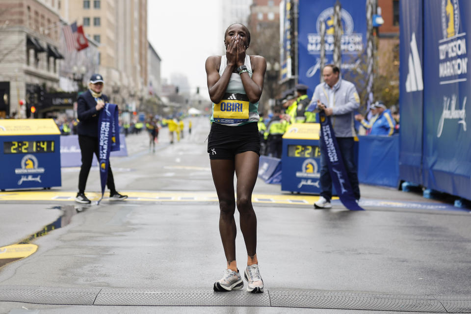 Hellen Obiri of Kenya covers her face after winning the women's division of the127th Boston Marathon Monday, April 17, 2023, in Boston. (AP Photo/Winslow Townson)