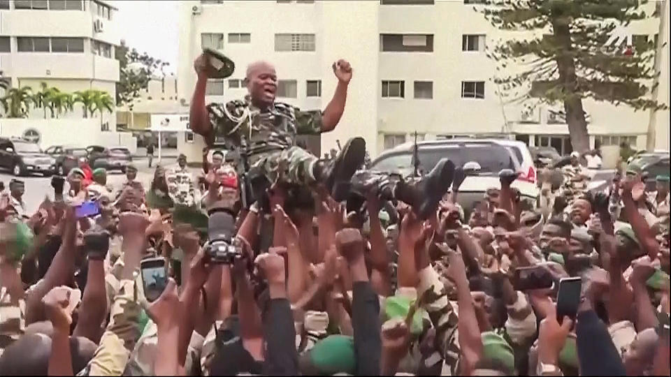 This video grab shows soldiers holding General Brice Clothaire Oligui Nguema aloft in Libreville, Gabon, Wednesday Aug. 30, 2023. Mutinous soldiers speaking on state television announced that they had seized power in and were overturning the results of a presidential election that was to extend the Bongo family's 55-year hold on power. (Gabon24 via AP)