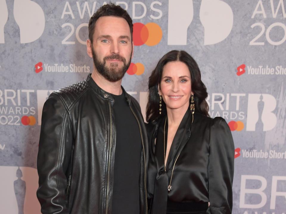 Johnny McDaid and Courteney Cox arrive at The BRIT Awards 2022 at The O2 Arena on February 8, 2022 in London, England