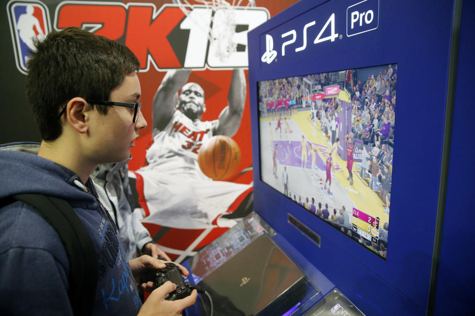 PARIS, FRANCE - NOVEMBER 01:  Gamers play the video game 'NBA 2K18' developed by Visual Concepts and published by 2K Sports on Sony PlayStation game consoles PS4 Pro during the 'Paris Games Week' on November 01, 2017 in Paris, France. 'Paris Games Week' is an international trade fair for video games to be held from October 31 to November 5, 2017.  (Photo by Chesnot/Getty Images)