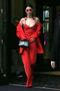 <p>In an Area red bustier tank top, trousers, and coat with a jeweled choker, Ambush red tinted sunglasses, pointed-toe heels and Dior crocodile leather handbag while out in Paris.</p>