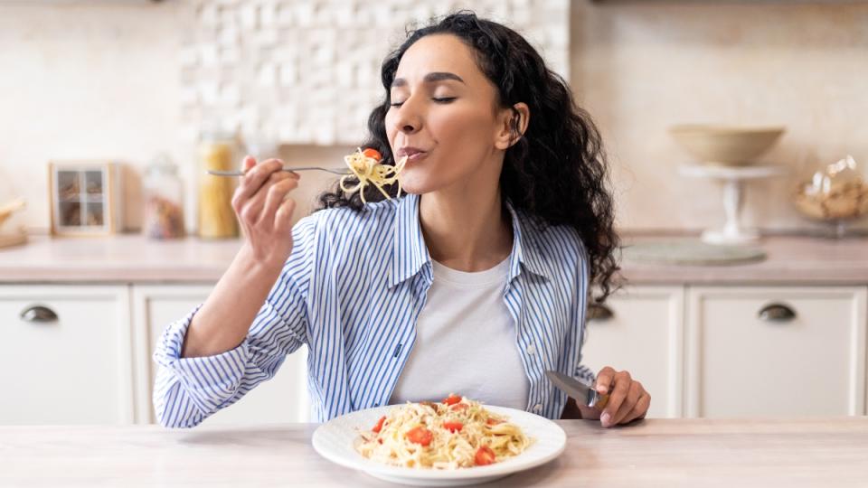 Woman eating pasta