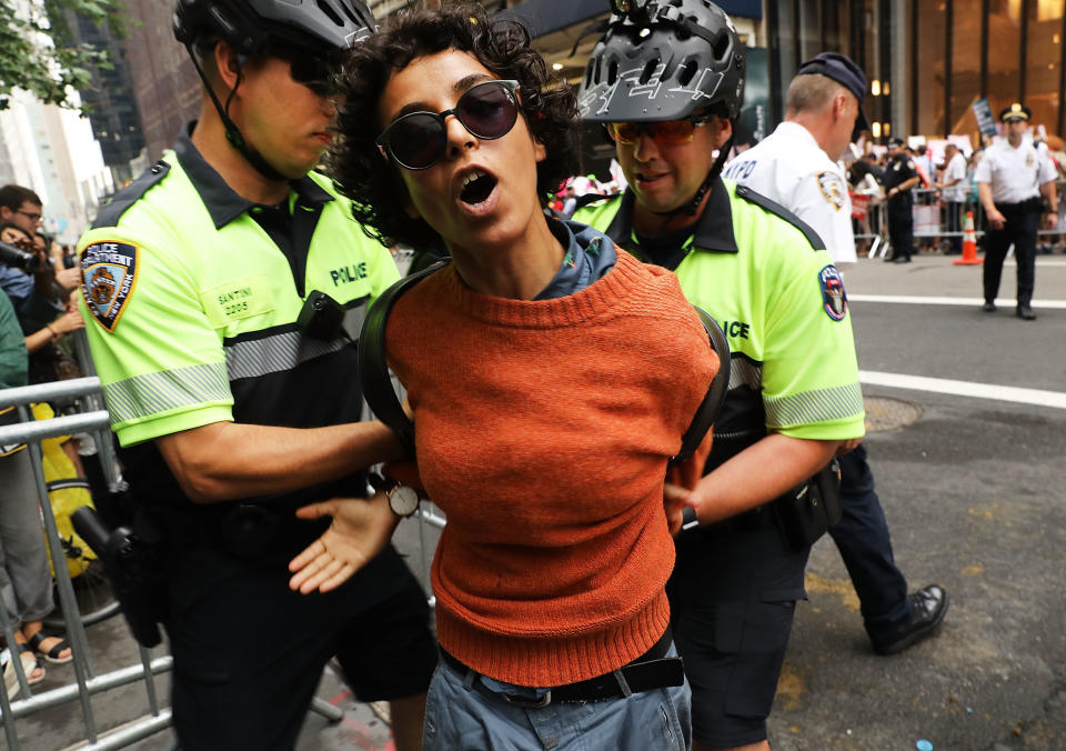 A woman is arrested during a pro-immigration rally outside Trump Tower on Aug. 15, 2017, in New York City.
