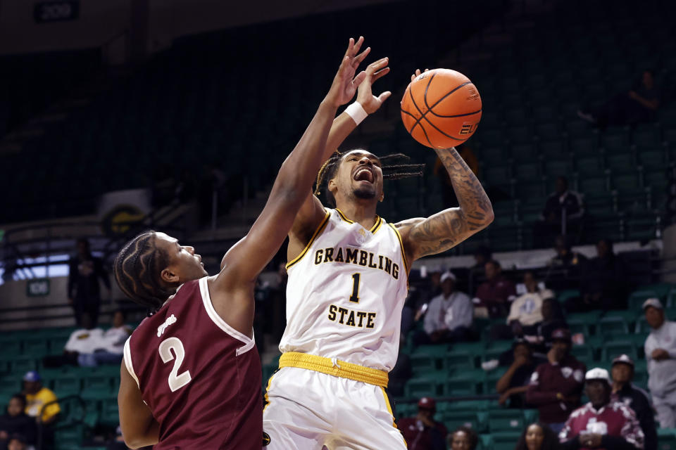 Texas Southern forward Davon Barnes (2) blocks the shot attempt of Grambling State guard Cameron Christon (1) during the first half of an NCAA college basketball game in the championship of the Southwestern Athletic Conference Tournament, Saturday, March 11, 2023, in Birmingham, Ala. (AP Photo/Butch Dill)