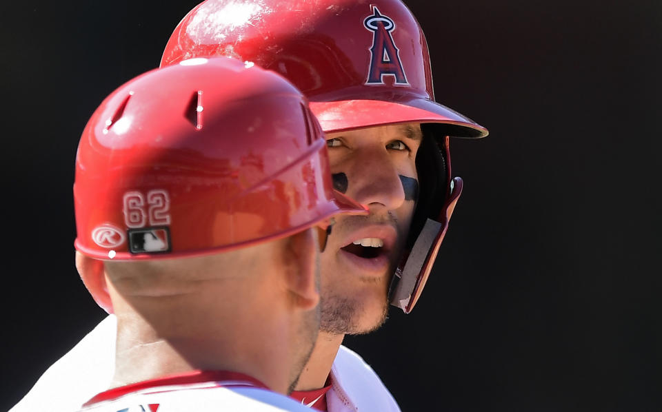 Los Angeles Angels' Mike Trout, right, stands on first as he talks to first base coach Jesus Feliciano during the sixth inning of a baseball game against the Texas Rangers Saturday, April 6, 2019, in Anaheim, Calif. (AP Photo/Mark J. Terrill)