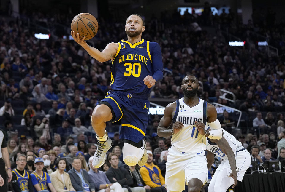 SAN FRANCISCO, CALIFORNIA - FEBRUARY 04: Stephen Curry #30 of the Golden State Warriors goes in for a layup in front of Tim Hardaway Jr. #11 of the Dallas Mavericks during the third quarter at Chase Center on February 04, 2023 in San Francisco, California. NOTE TO USER: User expressly acknowledges and agrees that, by downloading and or using this photograph, User is consenting to the terms and conditions of the Getty Images License Agreement. (Photo by Thearon W. Henderson/Getty Images)