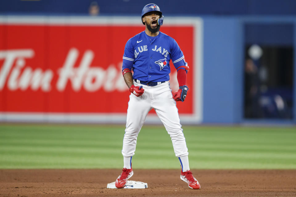 Toronto Blue Jays' Teoscar Hernandez celebrates on second base after hitting a double against the New York Yankees in the fourth inning of baseball game action in Toronto, Monday, Sept. 26, 2022. (Cole Burston/The Canadian Press via AP)