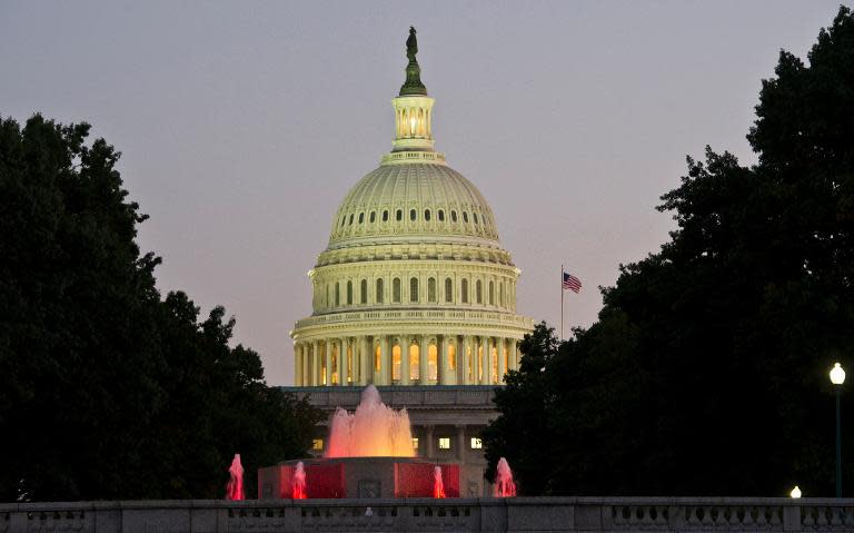 The US Congress building is seen at dusk on the eve of a possible government shutdown as Congress battles out the budget in Washington, DC, September 30, 2013