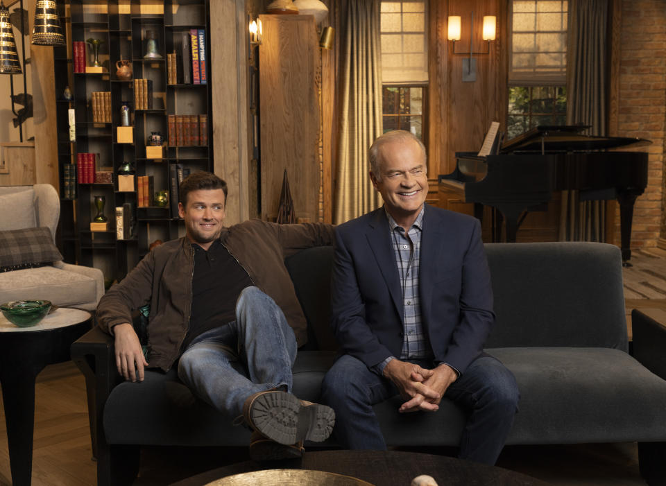Episodic photo of Jack Cutmore-Smith as Freddy Crane sitting on the couch with Kelsey Grammer as Frasier Crane in 'Frasier' revival