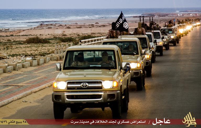 Members of the Islamic State (IS) group are purportedly seen parading in a street in Libya's coastal city of Sirte in an image made available by propaganda Islamist media outlet Welayat Tarablos
