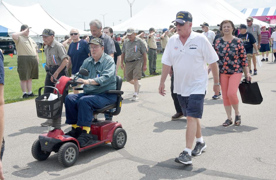 Veterans taking a walk around the Monroe County Fairgrounds were applauded by fairgoers and saluted by Boy Scout Troop 1948 Monday at the fair.