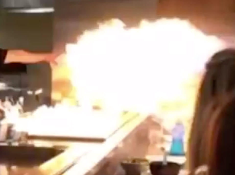 Flames comes off a hot plate at a restaurant.