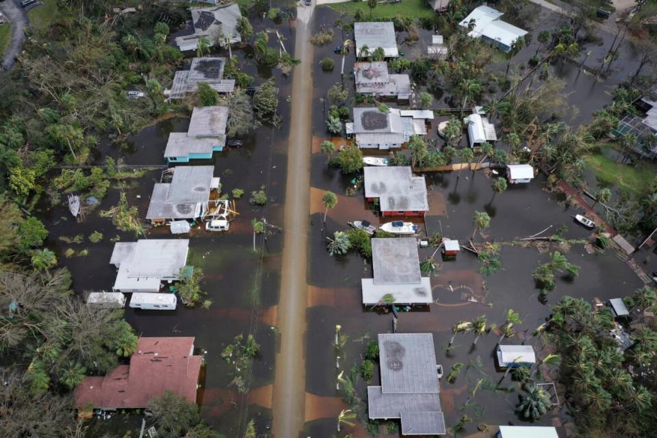Flooded homes are shown in an aerial view of Port Charlotte, Florida, on Sept. 29 after Hurricane Ian moved through the state’s Gulf Coast. The majority of homeowners there do not have federal flood insurance. FEMA’s chief is urging homeowners to get coverage even if they are not in a hazard zone. (Photo: Win McNamee/Getty Images)