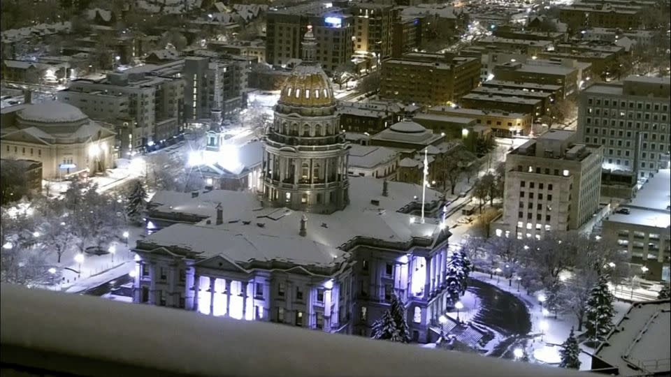 The Colorado State Capitol is covered in snow early Thursday, March 14, 2024 in Denver. - KMGH via AP