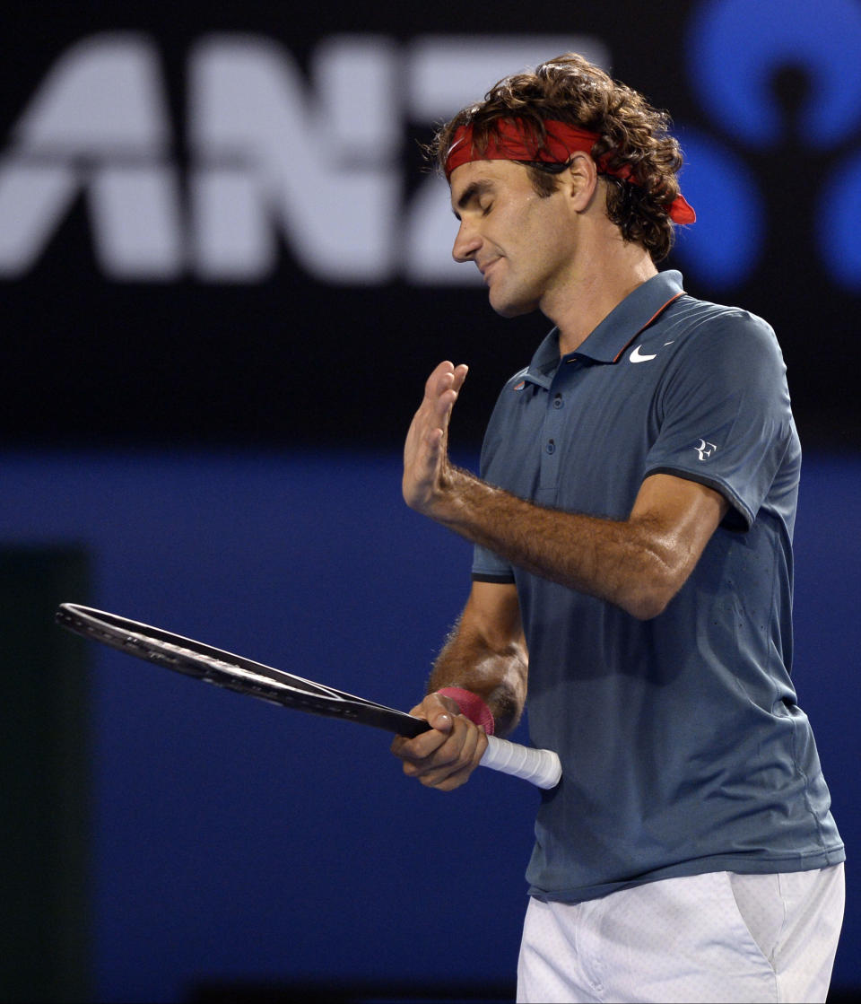 Roger Federer of Switzerland reacts after losing a point to Rafael Nadal of Spain during their semifinal at the Australian Open tennis championship in Melbourne, Australia, Friday, Jan. 24, 2014.(AP Photo/Andrew Brownbill)