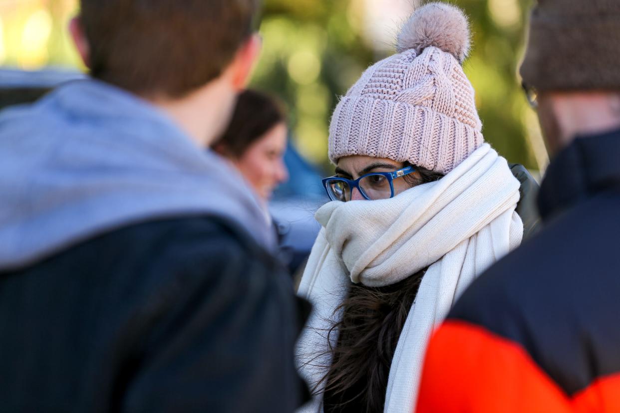 Kimia Lalezari covers her head and face with a beanie and thick scarf after the outside temperature dropped nearly 50 degrees overnight in Austin, Texas on Jan. 2, 2022.